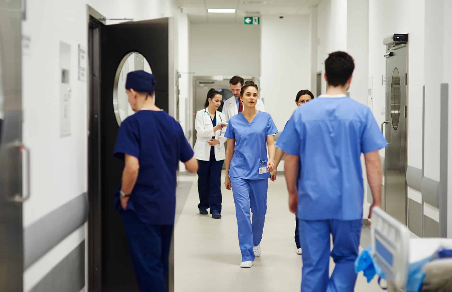 A hospital hallway full of doctors and nurses