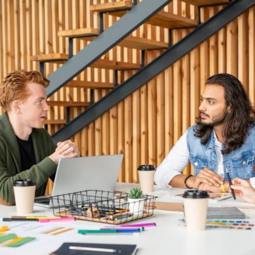 Creative people collaborate around a table at work