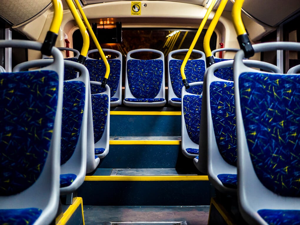 Rows of seats in an empty transit bus
